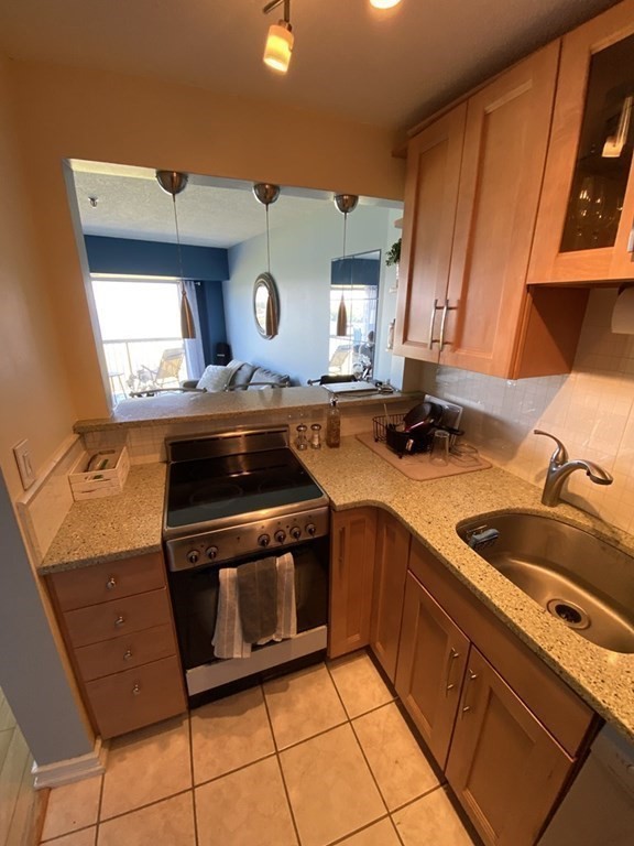 133 Commander Shea Boulevard, Unit 711 Quincy, MA 02171 - Photo 7 of 21 a kitchen with a stove and a sink