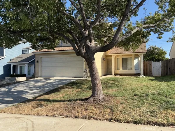 a view of a house with a tree
