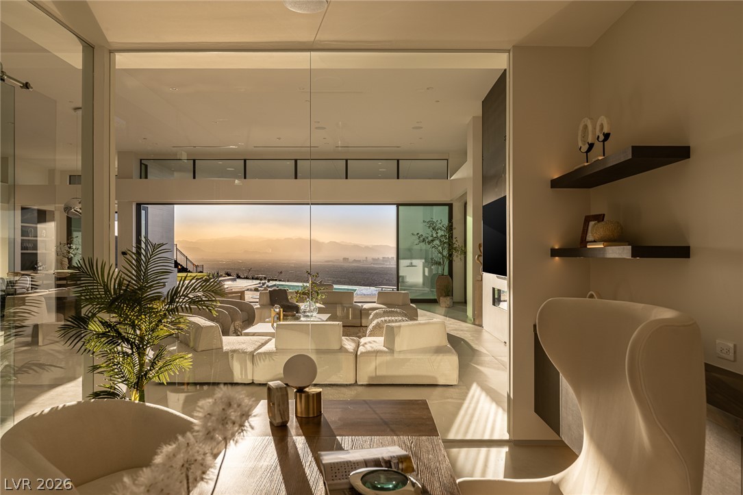 563 Grand Rim Drive Henderson, NV 89012 - Photo 19 of 70 Floor-to-ceiling windows offer panoramic views from this modern living space, perfect for entertaining.