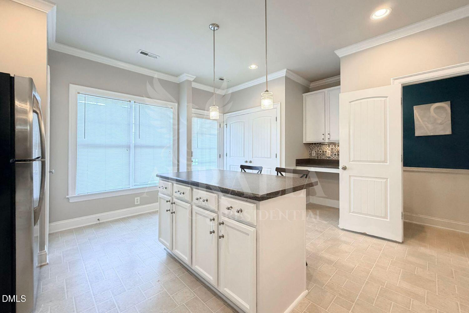 7754 ACC Boulevard Raleigh, NC 27617 - Photo 8 of 41 a kitchen with granite countertop a sink a counter space appliances and cabinets