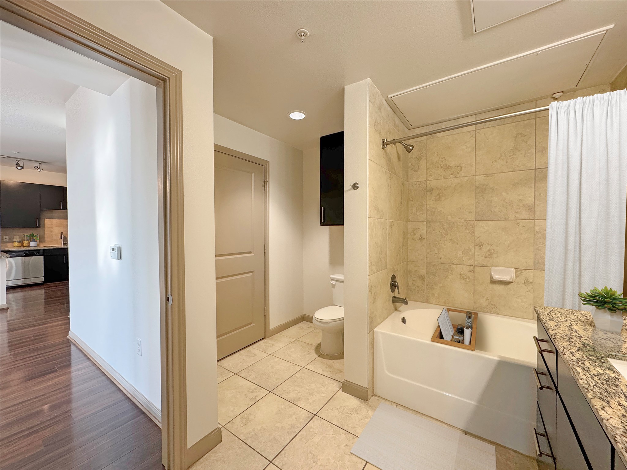 2700 Brazos Street, Unit 4303 Houston, TX 77006 - Photo 5 of 21 Shower-tub combo. Vanity has plenty of extra storage.