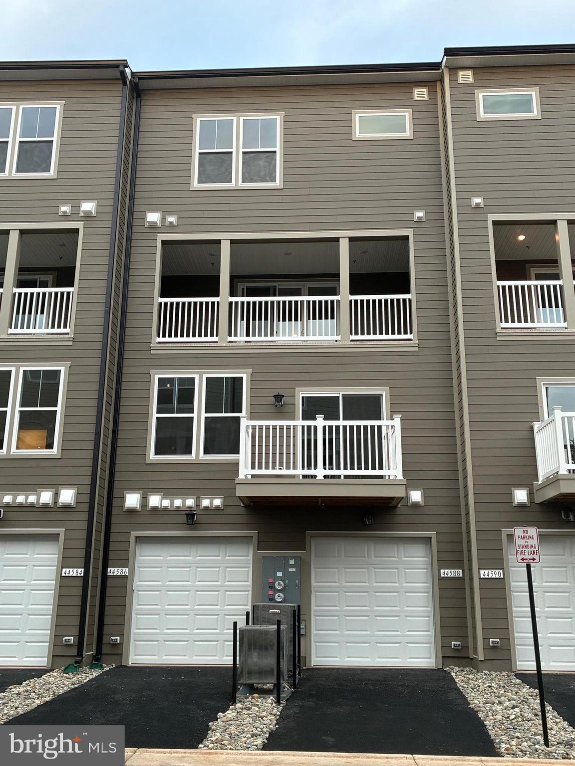 44586 Strabane Terrace Ashburn, VA 20147 - Photo 2 of 15 a front view of a house with a garage
