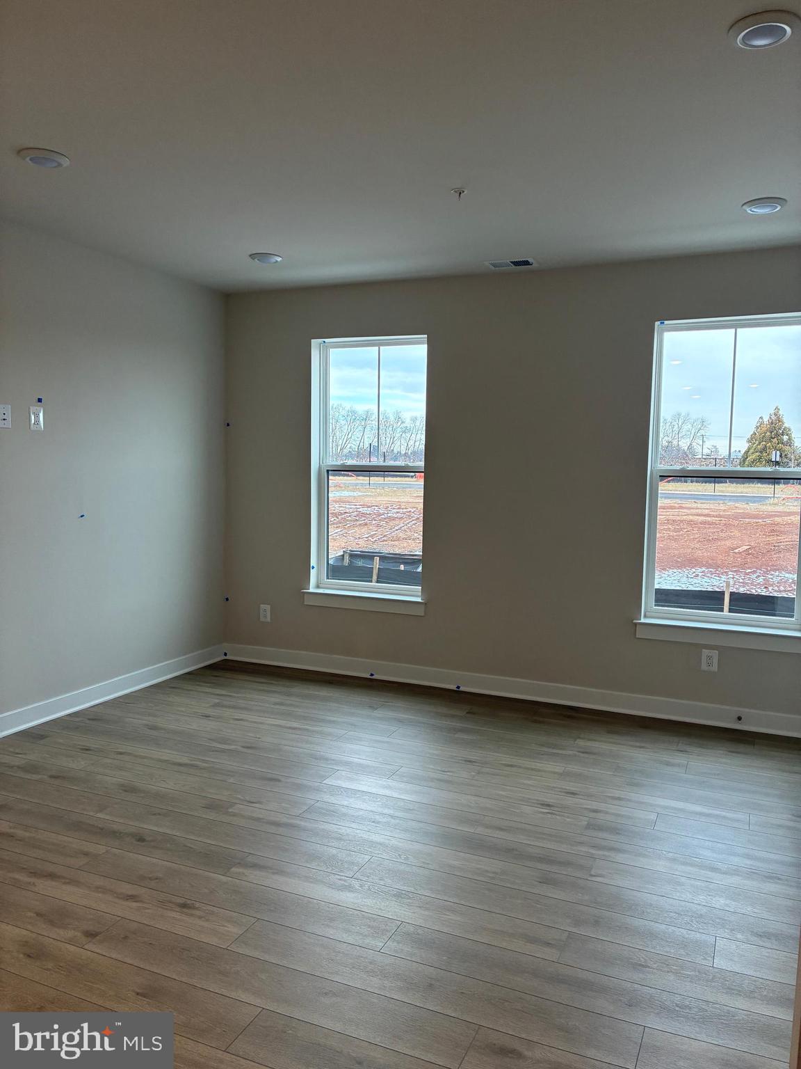 44586 Strabane Terrace Ashburn, VA 20147 - Photo 3 of 15 an empty room with wooden floor and windows