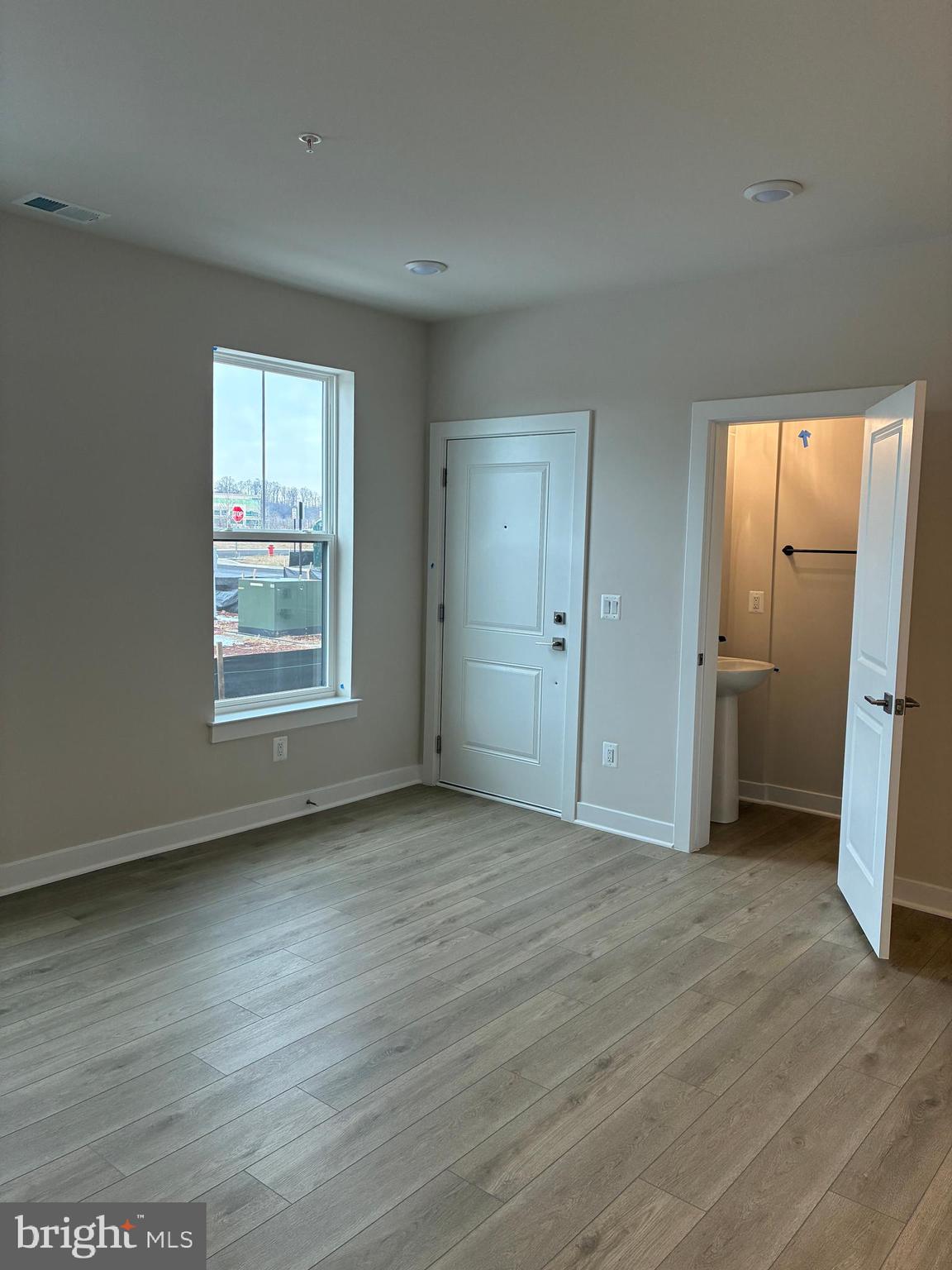 44586 Strabane Terrace Ashburn, VA 20147 - Photo 4 of 15 an empty room with wooden floor and a window