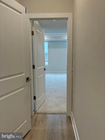 a view of a hallway with wooden floor