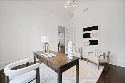 a living room with furniture a fireplace and a large window