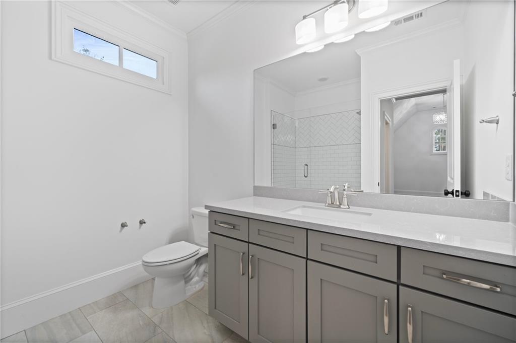 3213 Balley Forrest Drive Milton, GA 30004 - Photo 45 of 90 a bathroom with a toilet a sink and mirror