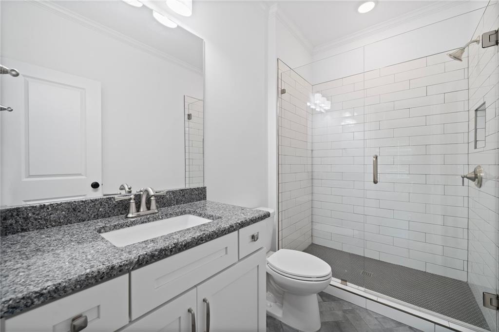 3213 Balley Forrest Drive Milton, GA 30004 - Photo 48 of 90 a bathroom with a granite countertop sink toilet and shower
