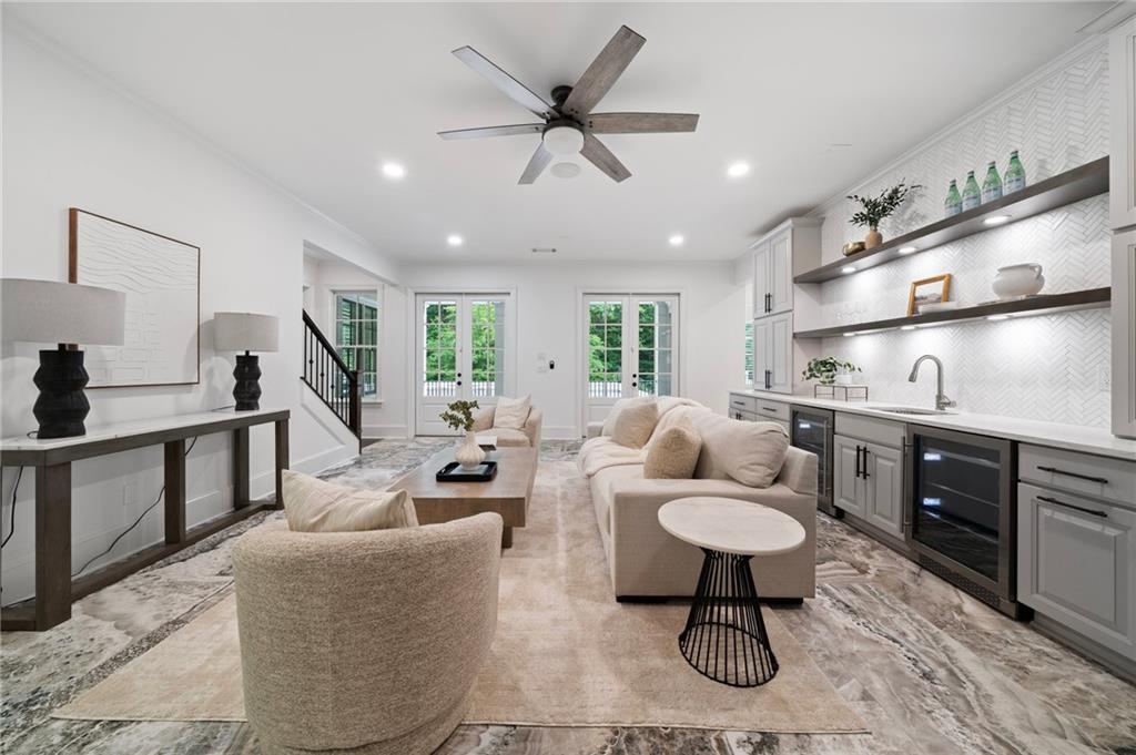 3213 Balley Forrest Drive Milton, GA 30004 - Photo 56 of 90 a living room with furniture a rug and a chandelier