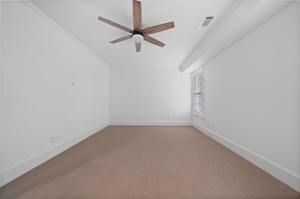 3213 Balley Forrest Drive Milton, GA 30004 - Photo 64 of 90 an empty room with a ceiling fan and window