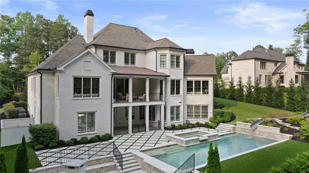 3213 Balley Forrest Drive Milton, GA 30004 - Photo 70 of 90 a view of a white house with a yard table and chairs