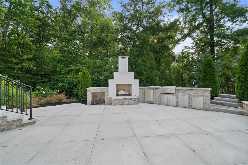 3213 Balley Forrest Drive Milton, GA 30004 - Photo 76 of 90 a view of a terrace with a bench and trees
