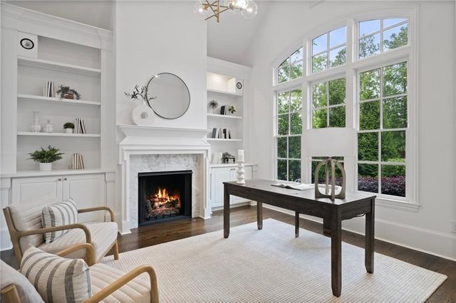 a view of a dining room with furniture large windows and wooden floor