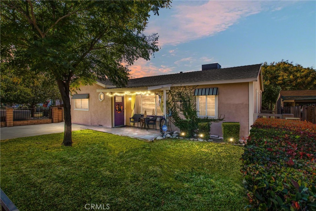 a view of a house with a yard and tree s