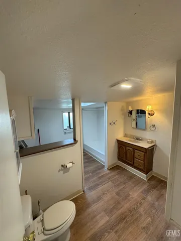 a spacious bathroom with a sink a toilet and a mirror