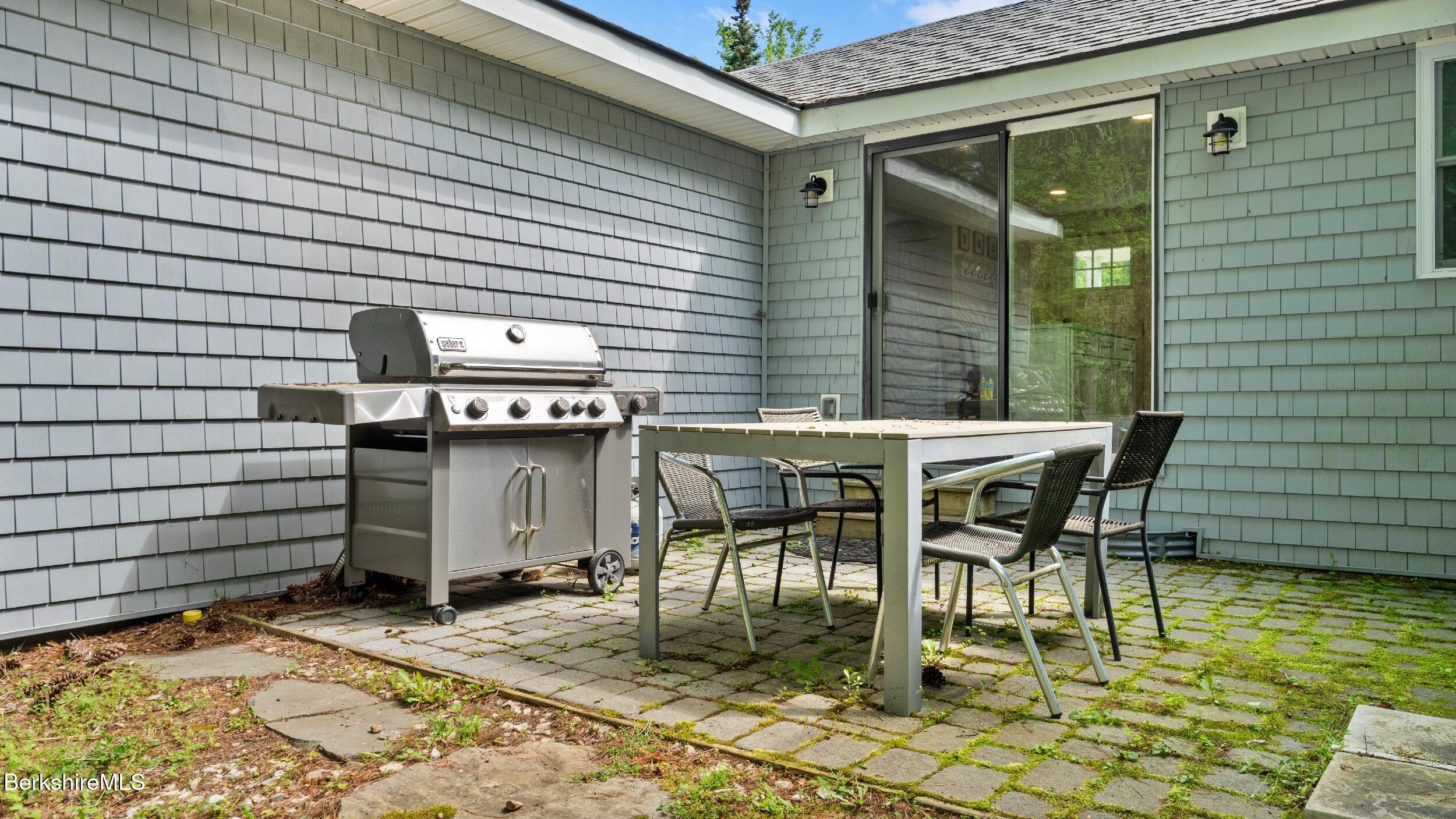 418 Monterey Road Great Barrington, MA 01230 - Photo 23 of 28 a patio with table and chairs and potted plants