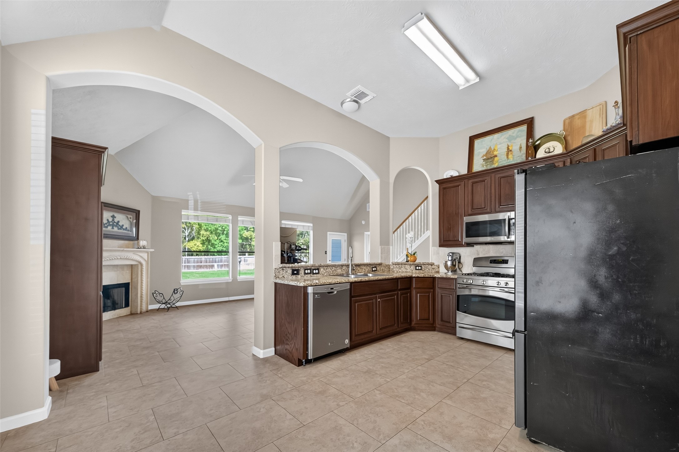 19207 Pinewood Mist Lane Humble, TX 77346 - Photo 9 of 29 a kitchen with stainless steel appliances granite countertop a stove top oven a sink and dishwasher