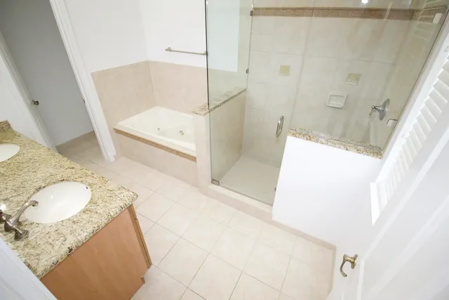 a bathroom with a tub sink and a mirror