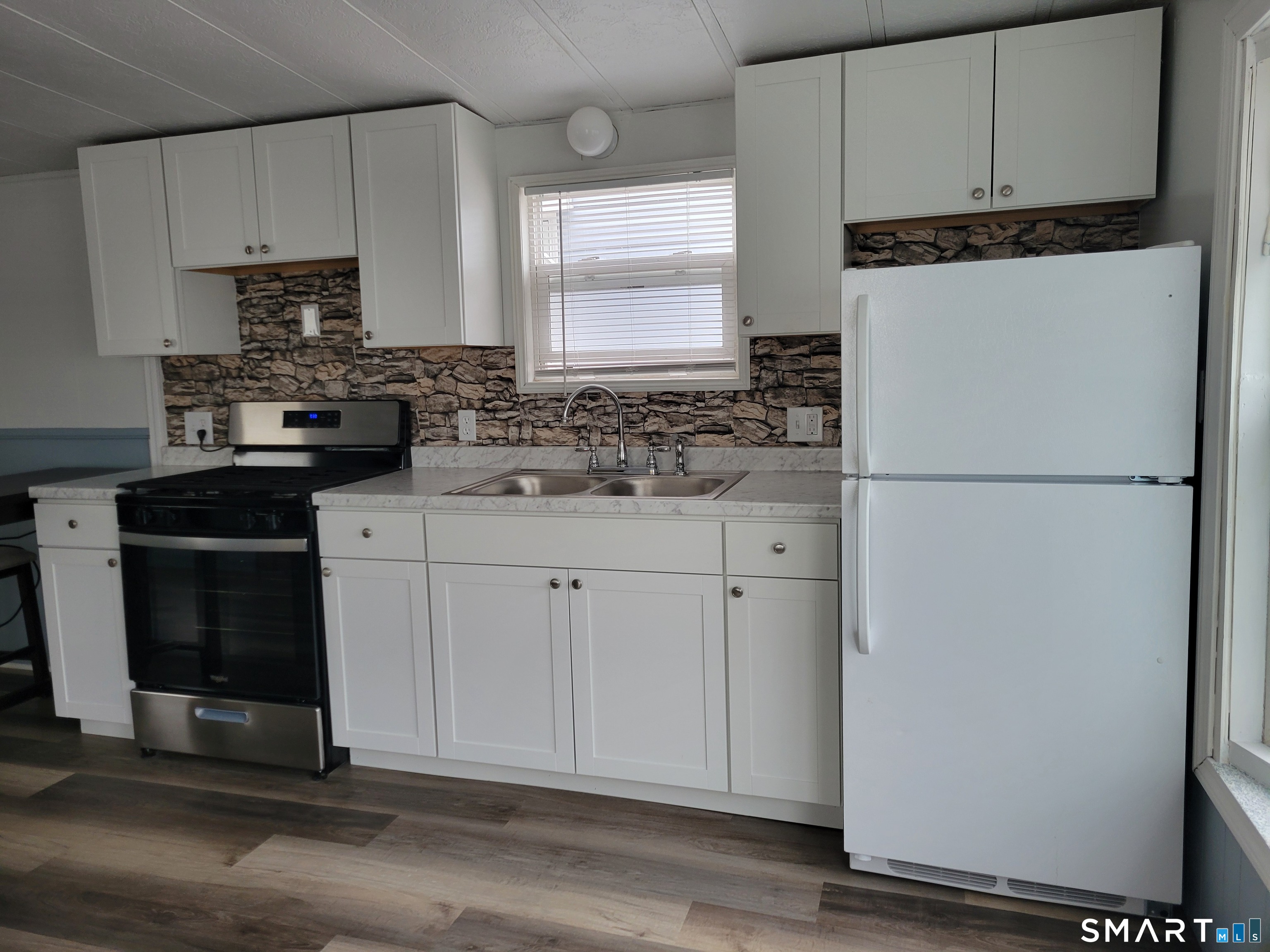 1290 N Road Groton, CT 06340 - Photo 2 of 11 a kitchen with appliances cabinets and a counter top space