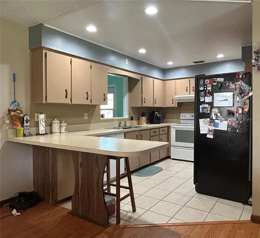 a utility room with a sink and a wooden floor