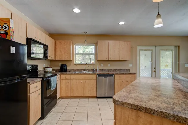 a living room with furniture a fireplace and a large window