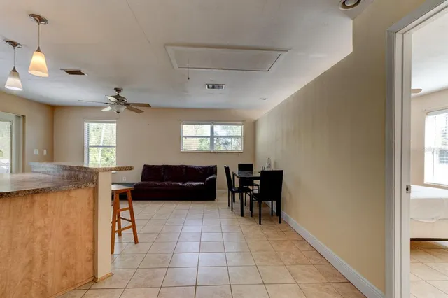 a living room with furniture fireplace and a large window