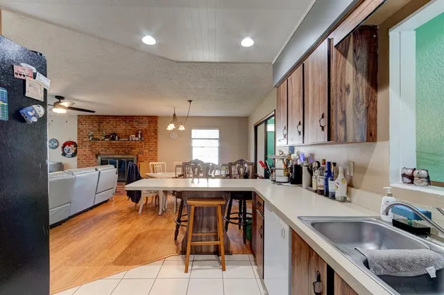 a living room with furniture a dining table and a fireplace