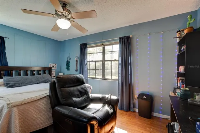 an aerial view of a house with a yard lake and trees