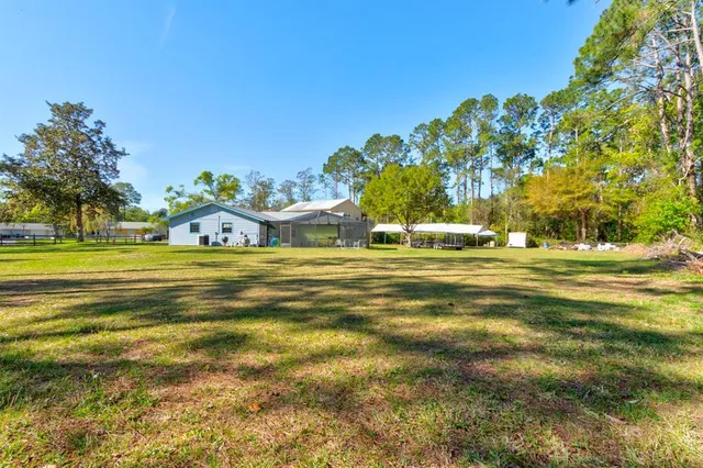 a view of a house with swimming pool and porch with furniture