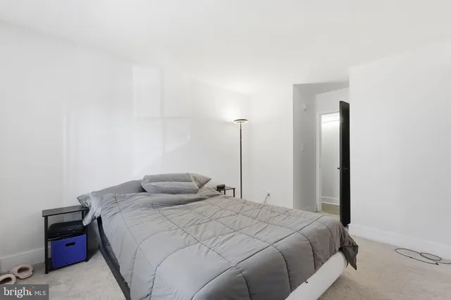 a bedroom with a bed and night stand