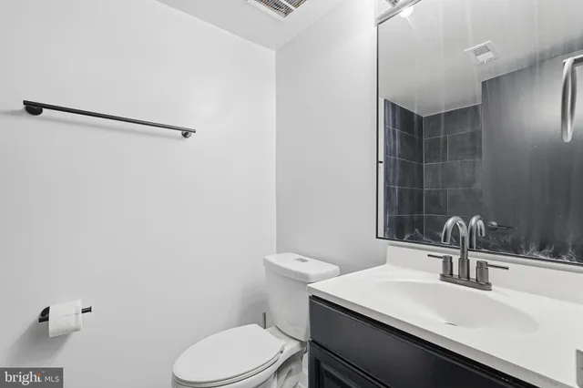a bathroom with a sink toilet and mirror