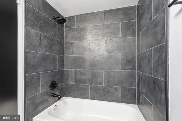 a bath tub sitting next to a bathroom sink
