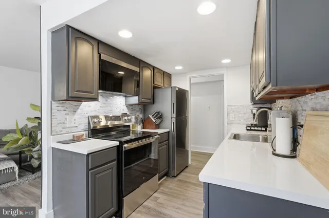 a kitchen with a sink stove and refrigerator