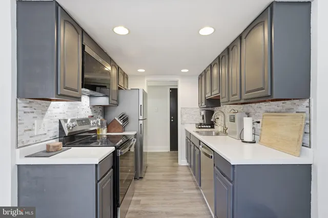 a kitchen with a sink stove and cabinets