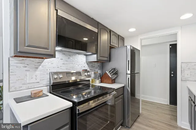a kitchen with a stove and a refrigerator