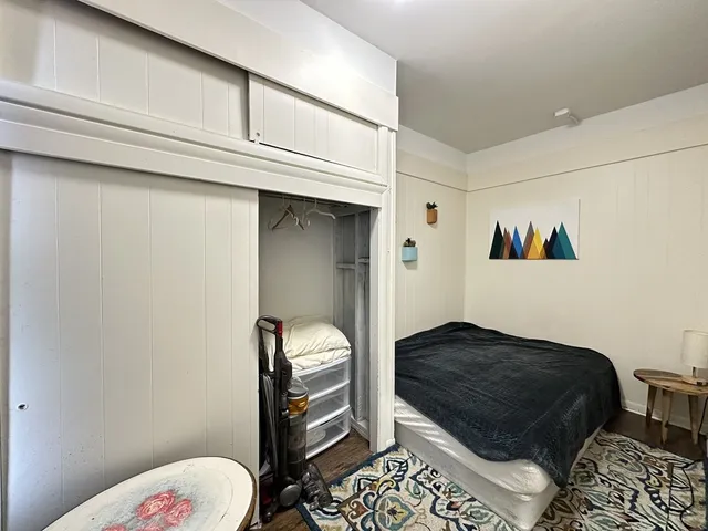 a bedroom with a bed and a dresser