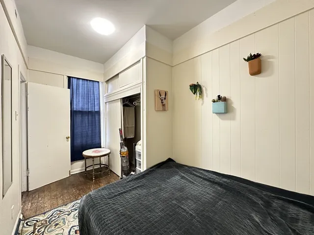 a bedroom with a bed and a table in it