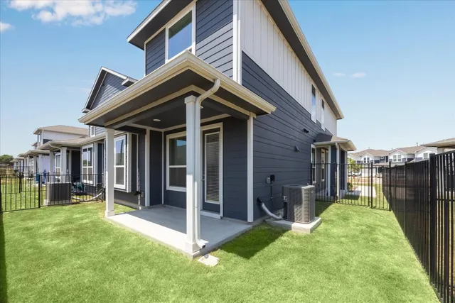 a view of a house with a yard and furniture
