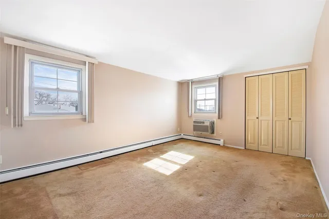 a bedroom with a bed a couch and a potted plant