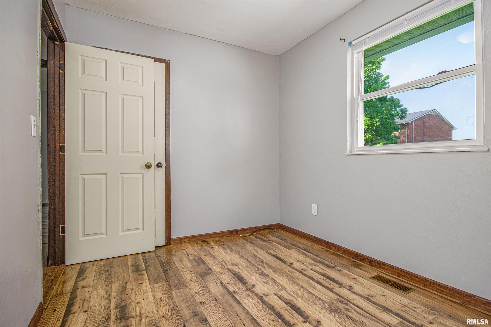 518 Roddy Road Salem, IL 62881 - Photo 17 of 24 a view of empty room with wooden floor and fan