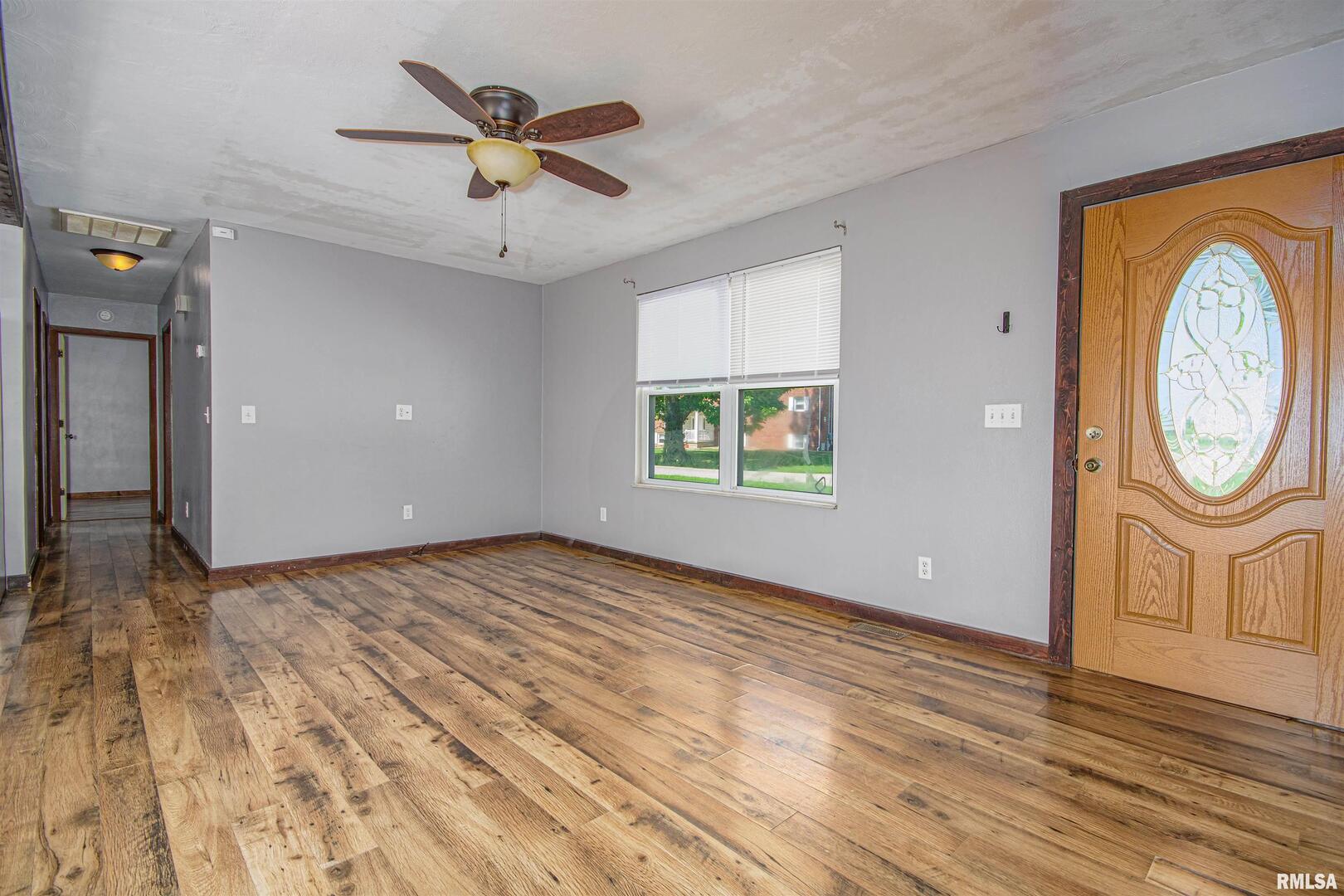518 Roddy Road Salem, IL 62881 - Photo 3 of 24 a view of empty room with wooden floor and fan