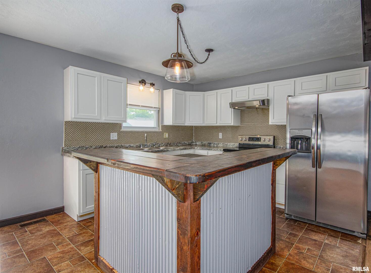 518 Roddy Road Salem, IL 62881 - Photo 8 of 24 a kitchen with stainless steel appliances granite countertop a sink a refrigerator a center island a stove and a window