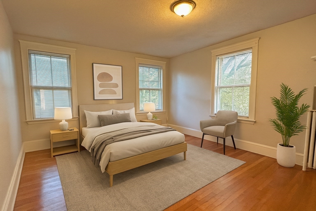 399 Newtonville Avenue, Unit 2 Newton, MA 02460 - Photo 11 of 24 a bedroom with a large bed and windows