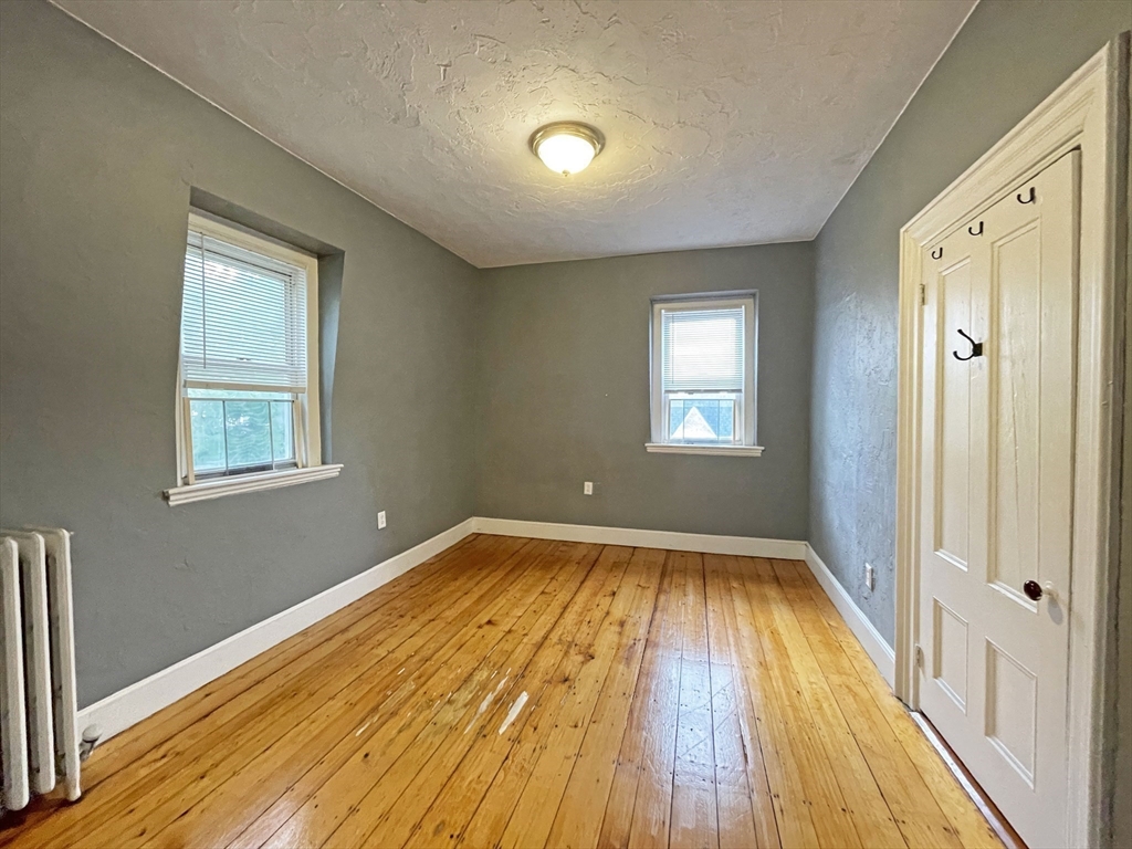 399 Newtonville Avenue, Unit 2 Newton, MA 02460 - Photo 17 of 24 a view of a room with wooden floor and window