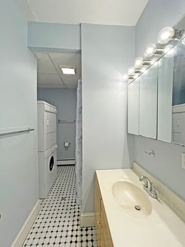 a bathroom with a sink a shower and a mirror