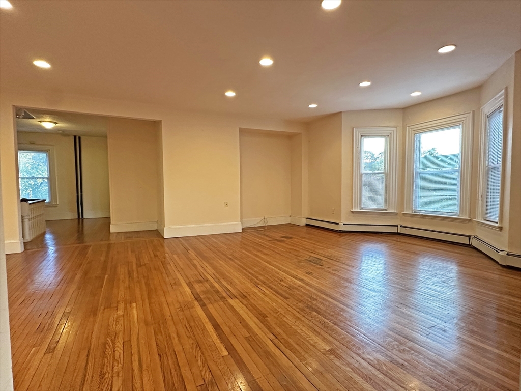 399 Newtonville Avenue, Unit 2 Newton, MA 02460 - Photo 2 of 24 a view of empty room with wooden floor and fan