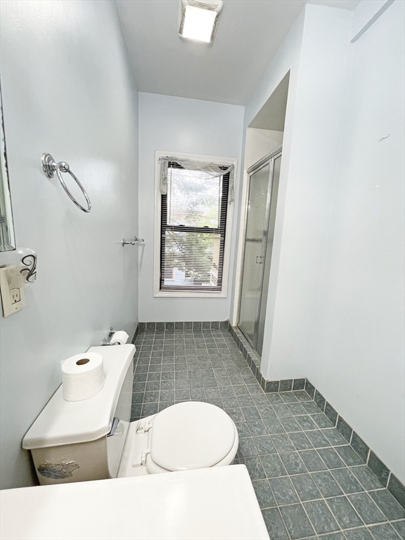 399 Newtonville Avenue, Unit 2 Newton, MA 02460 - Photo 22 of 24 a bathroom with a sink a toilet and tub