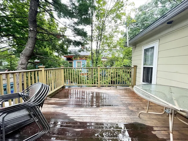 a view of balcony with wooden floor and outdoor seating
