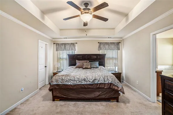 a bedroom with a bed and a ceiling fan