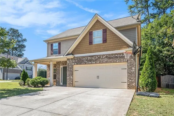a front view of a house with a yard and garage
